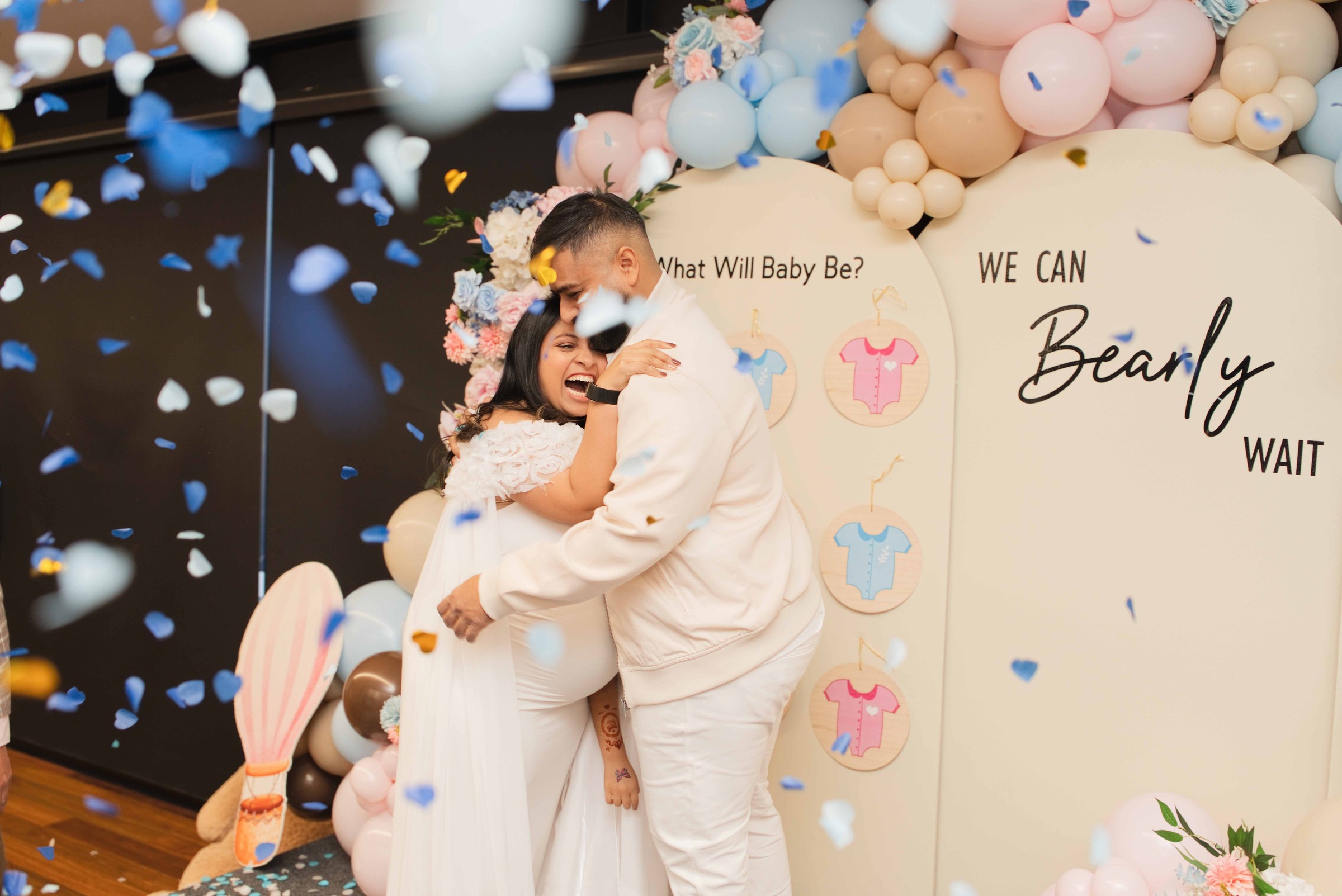 Honey and Tarak sharing a tight, emotional hug as blue confetti floats around them
