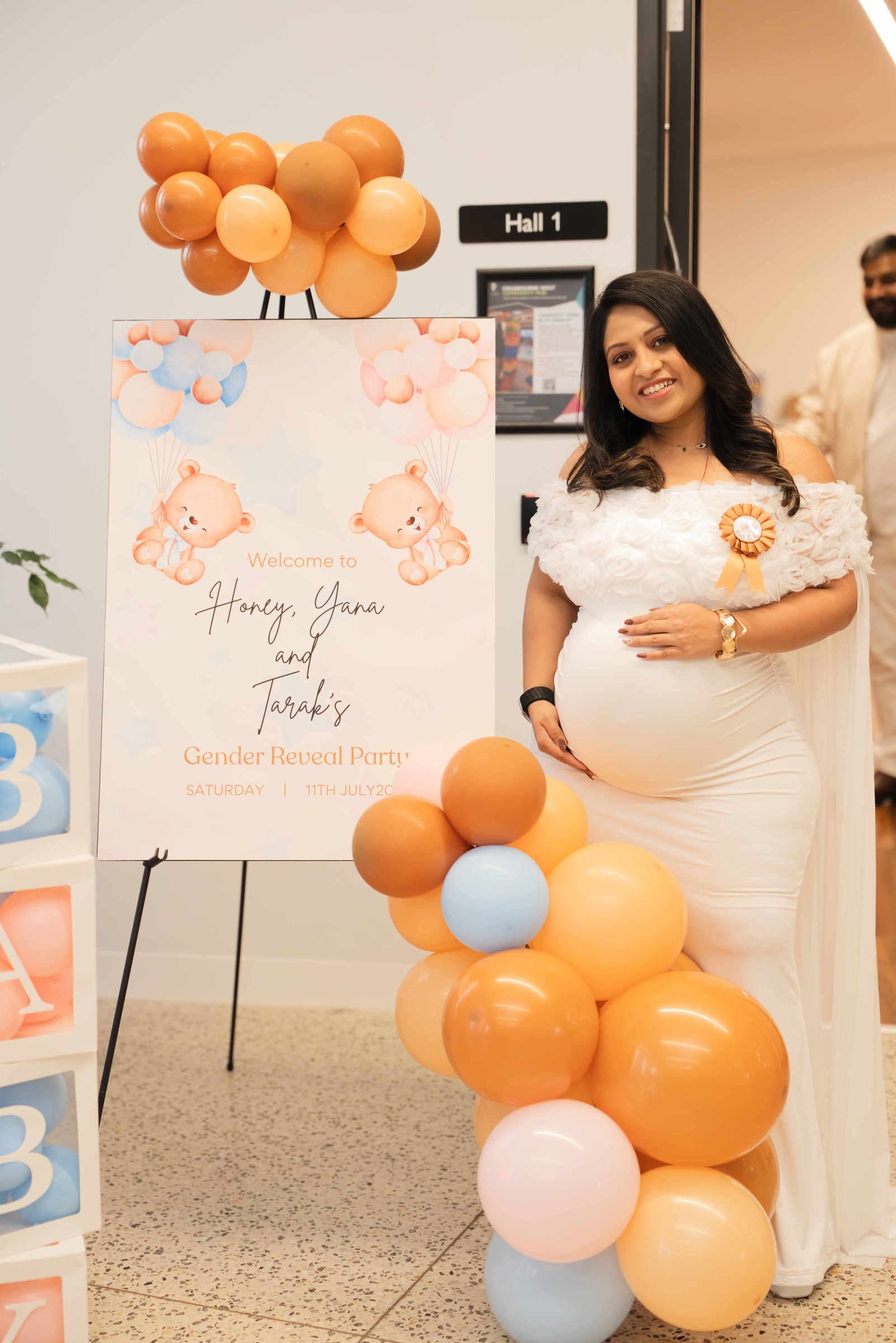 Welcome sign with a balloon garland at the entrance to the gender reveal party